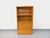 Vintage 1960s oak bookcase with a solid plinth, two open shelves with small removable shelves, two sliding doors, and one...