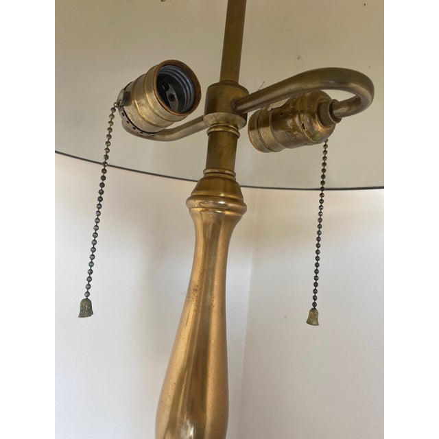 Unique vintage brass candlestick style table lamp with brass shade. Underside of shade is ivory enamel that has some wear...