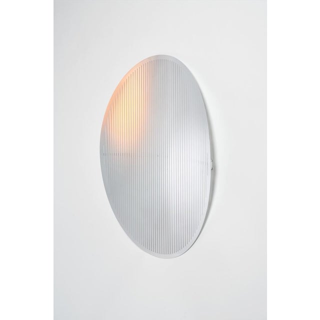 Echo oval wall mirror in polished aluminum by martens & visser. Dimensions: d 7 x w 58 x h 73 cm. Materials: aluminum. To...