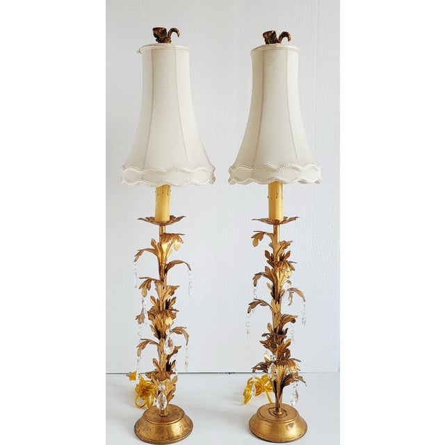 Pair of Chelsea House Rosetti metal buffet lamps in an antique gold finish, with leaf motif and crystal prisms. Chelsea...