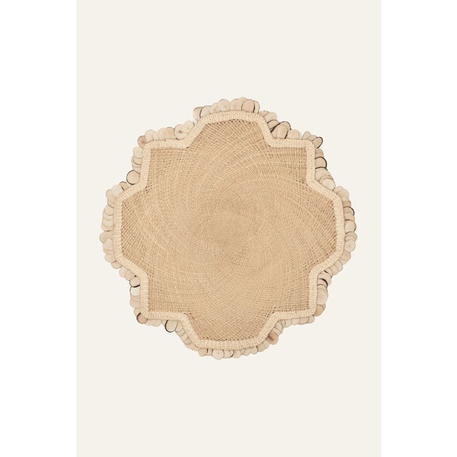 Johanna Ortiz's "Casa Collection '24" showcases placemats crafted by women artisans from Sandoná, Colombia, using iraca...