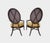 An excellent pair of oval x-back dining chairs designed by Barbara Barry for The Mcguire Company. Finish: Dark Tobacco...