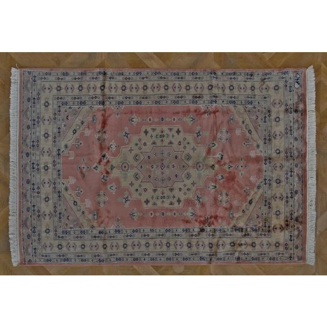 An elegant hand-knotted rug from Lahore, Pakistan, one of the major centers of traditional rug production. The rug...
