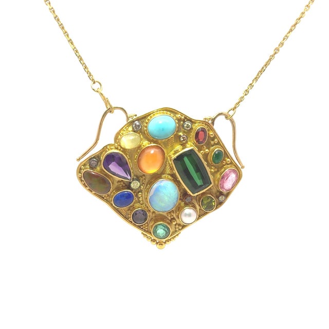 This dazzling pendant by goldsmith Luna Felix features a plethora of fine natural colored gemstones and diamonds. A...
