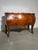 Elegant antique bombe chest of drawers featuring exceptional marquetry inlay work and a striking marble top. A refined...