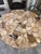 Stunning round dining table crafted from genuine petrified wood, featuring a one-of-a-kind mosaic stone top with natural...