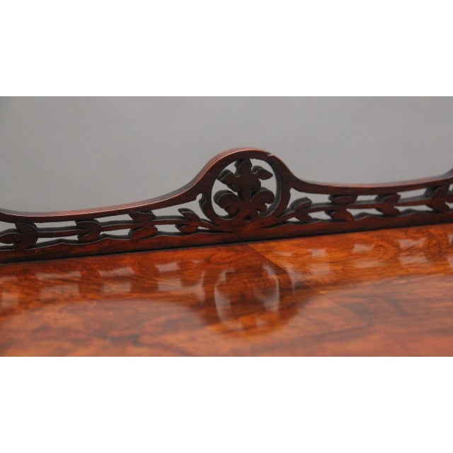 19th Century burr walnut three tier whatnot, the top tier having a pierced carved gallery and turned finials in each...