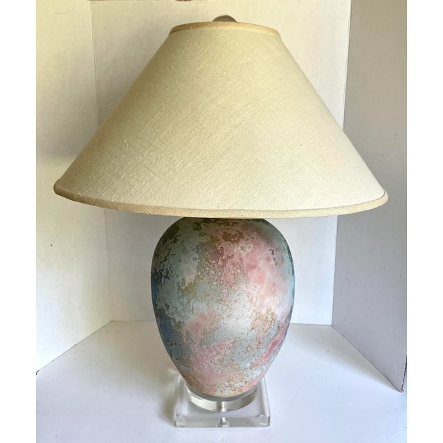 Here is an absolutely amazing table lamp from the 1980's featuring an egg shaped center base on a lucite stand with a...
