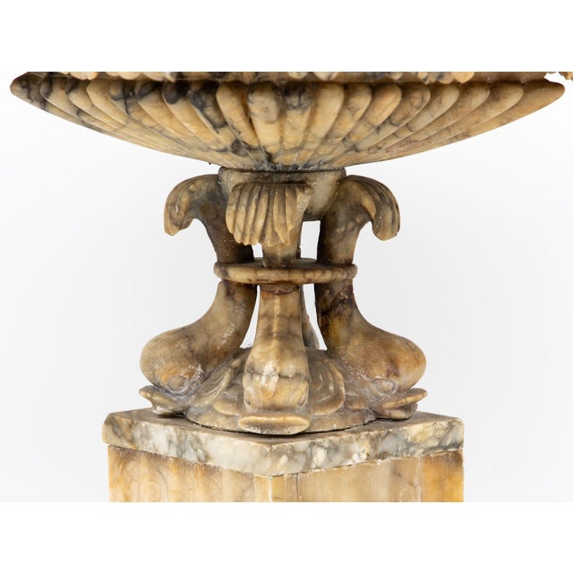 An exquisite 19th-century Italian Neoclassical carved marble urn in a distinctive diamond shape. Adorned with intricately...