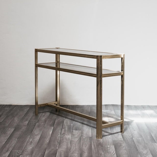 Gorgeous Hollywood Regency-style console made in Italy in the 1970s, featuring a refined gilded metal frame and double...