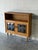 This versatile display cabinet features open upper shelving and an enclosed lower storage compartment with leaded glass...