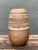 Dating to the Mid-Century Modern era, this vintage studio pottery vase is crafted from ceramic with a gently rounded body...