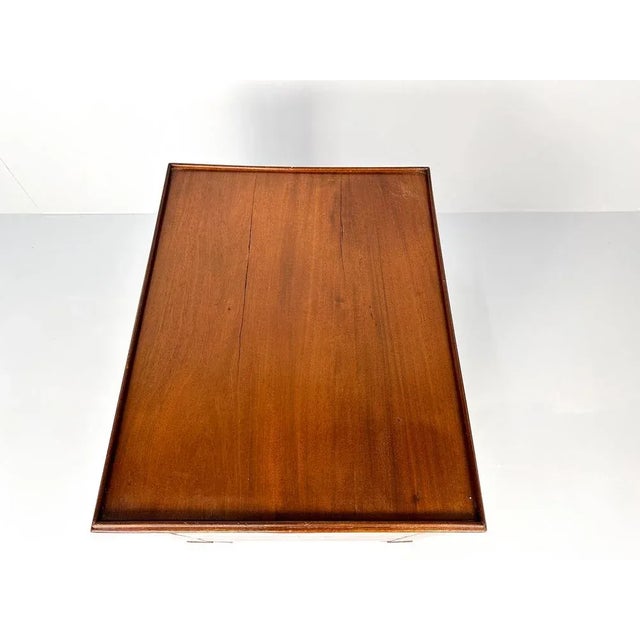 Beautiful antique bedside cabinet with roller door, standing on tapered legs. The top features a small, original raised...