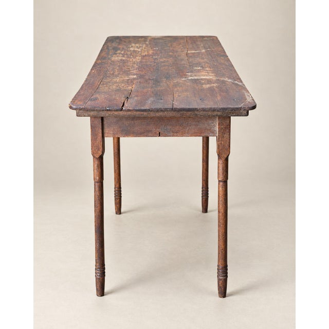 A wonderfully timeworn antique folding worktable, believed to have been used for tailoring, fabric measuring, or general...