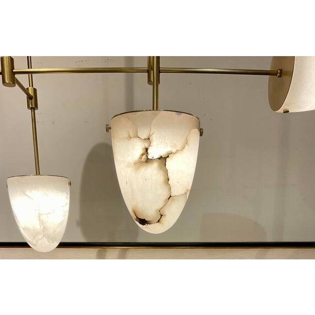 Original retail $4940, stylish Arteriors Modern Alabaster Alazani Chandelier, antique brass metal finished frame, showroom...