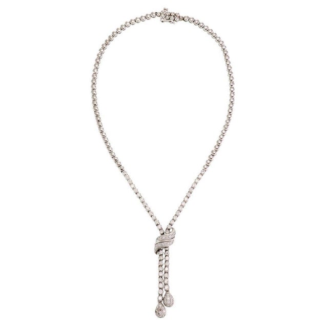 This is a beautiful double dangle lariat necklace, it is crafted from 14k white gold with a polished finish. The lower...