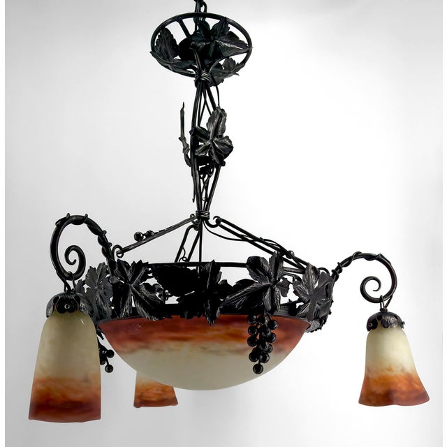 Art Deco Chandelier in Wrought Iron and Blown Glass by Muller Frères Lunéville, France, Circa 1920. We are pleased to...