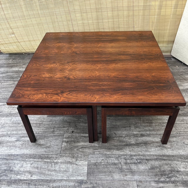 Danish Mid Century Modern Nesting Coffee Table by Arne Hovmand Olsen. Circa 1970s Features a minimalist Scandinavian...