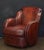 A fine vintage French leather upholstered club or lounge chair from the Art Deco era - featuring a comfortable shaped back...