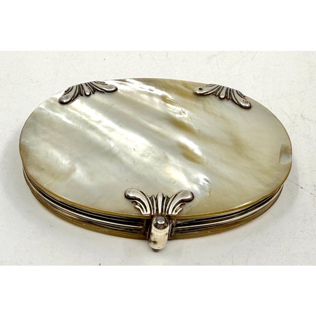 A lovely little looking glass that has a compact design. The glass part slides out. The case is Mother of Pearl with...