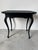 Elegant and refined, this Hollywood Regency Georgian-style occasional table features an ebonized black lacquer finish and...