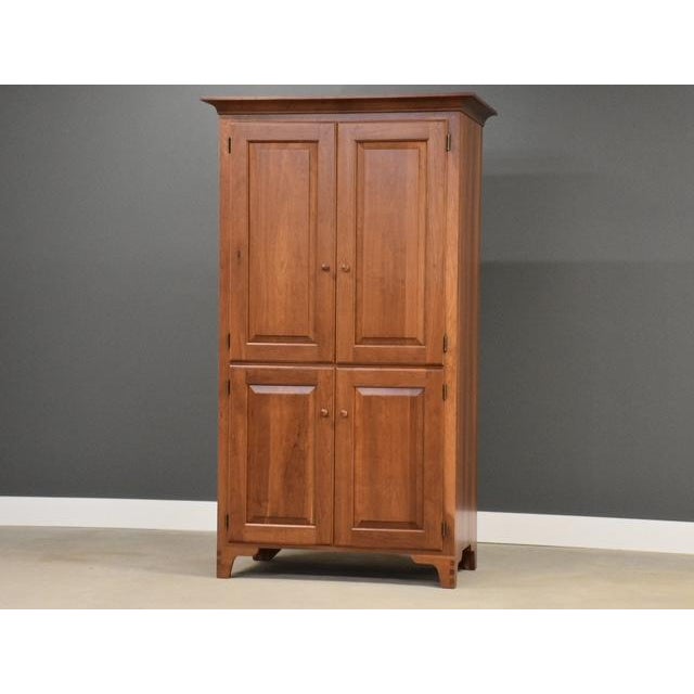 A solid cherry tall armoire dresser with exposed dovetails very well made. Professionally restored. Circa 1990’s. Made in...