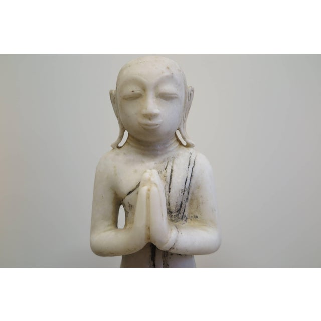 A Burmese Alabaster sculpture of a Buddhist Monk devotee, Buddha. This posture is called Namaskara mudra, or Anjali mudra...