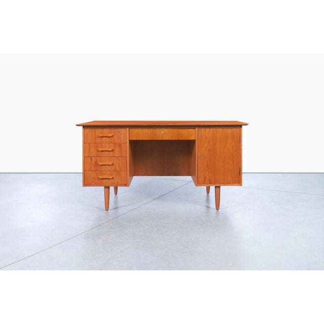 This Danish modern teak executive desk embodies the thoughtful craftsmanship and functionality that made Scandinavian...