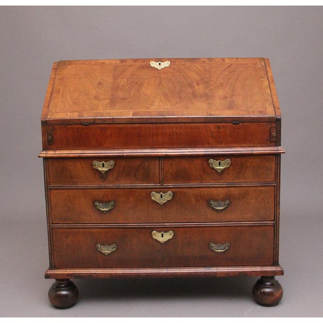 18th Century walnut bureau inlaid with herringbone, having a wonderful figured fall opening to reveal a lovely fitted...