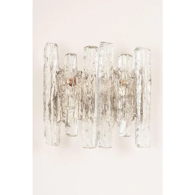 Wonderful midcentury wall sconce with ice glass, made by kalmar, austria, manufactured, circa 1960-1969. High quality and...