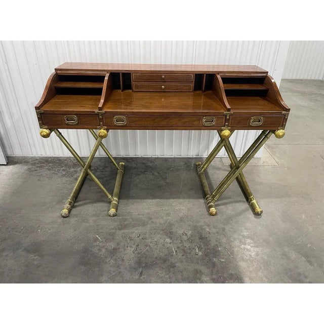 Campaign style desk designed by John Van Koert for Drexel. The desk is supported by gold crossed wood supports with a gilt...