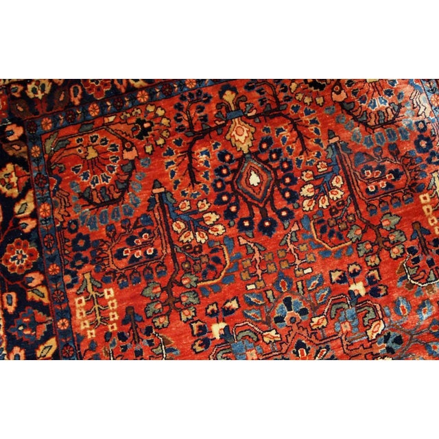 This antique Persian Sarouk rug made in the beginning of 20th century in red wool. The rug is in original good condition....