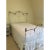 Alice's Antique white iron and bronze full size bed frame. Shape of the iron design on the headboard and footboard...