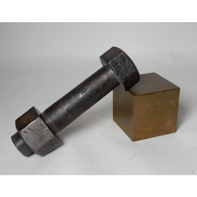 Large 1930's nut and bolt on a brass plinth. Forged of iron, not cast. Bolt is 13-1/2" long and weighs 20+ lbs. An amazing...