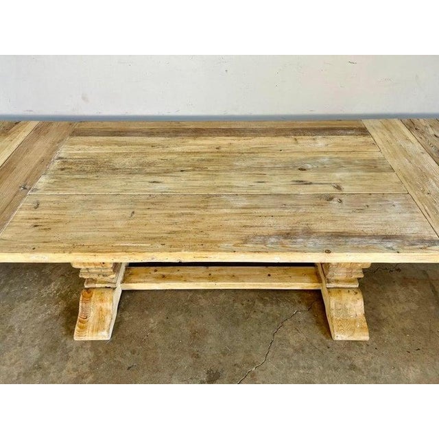 Italian Country pine table with two removable leaves. The table top stands on two pedestals and a bottom stretcher that...