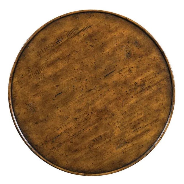 A round galleried top is raised by three curvaceously shaped legs that hold two low shelves. Care Instructions: Wipe with...