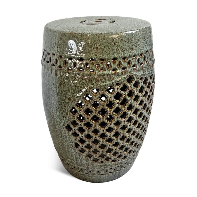 Ceramic green garden stool with cutout design and brown speckles. Great for use outdoors for unique extra seating or side...