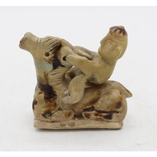 Qingbia-ware stoneware figurine, Song/Yuan dynasty, circa 960-1368. A boy on a water buffalo. The water buffalo is in a...