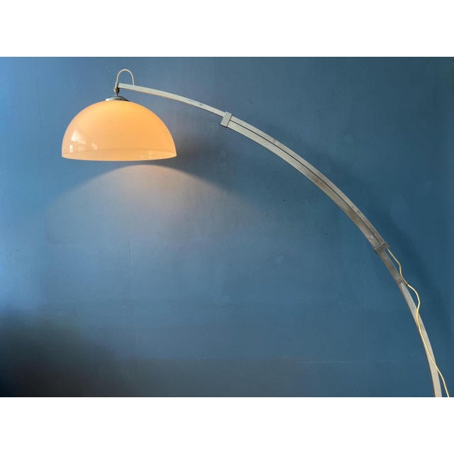 One of a kind arc floor lamp with extendable arm and mushroom shade. We are not sure about the brand, but it has the looks...