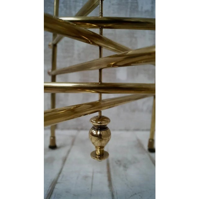 This elegant 1970s polished brass table sits delicately on six legs leading down to charming claw feet, oozing style, this...
