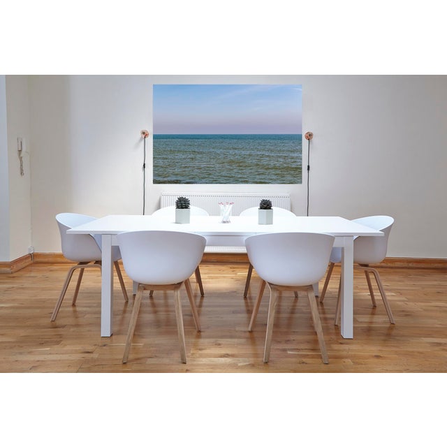 "Horizon Series". Each photo is divided into two halves, with the ocean in the upper half and the sky in the lower half....