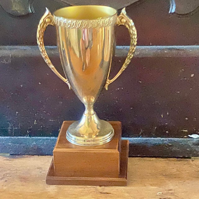 Here is a gold tone over metal cup trophy on a solid two tiered solid walnut base from the early 1960’s. No engraving.