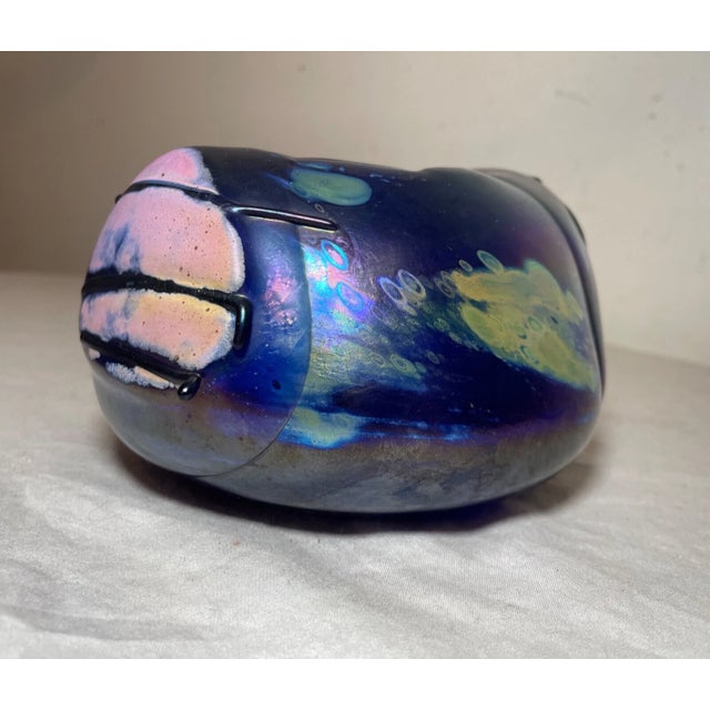 This stunning iridescent blue vase is a unique piece of art crafted by Pearson, a renowned glass blower in the wonderful...