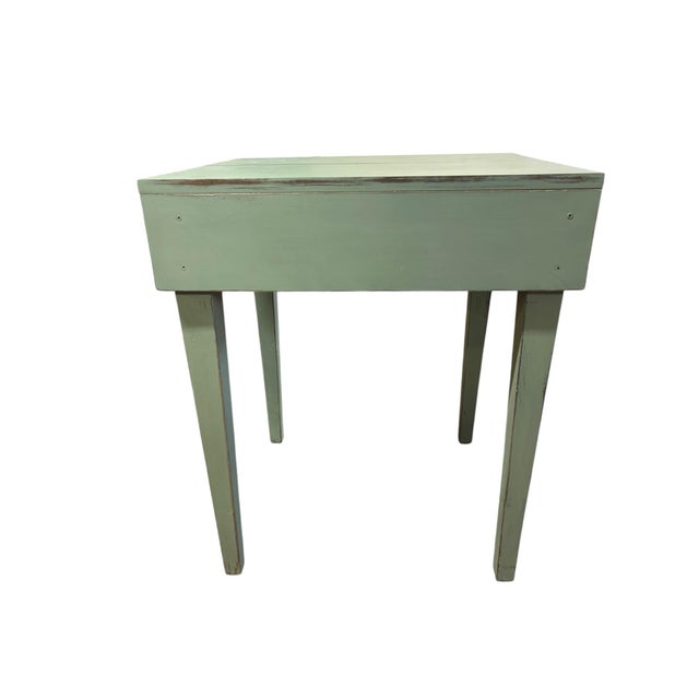 Charming primitive farmhouse table finished in a soft sage green with lightly distressed edges that reveal the natural...