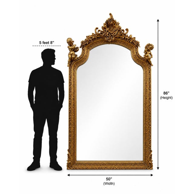 86" H x 50" W. Magnificent oversized giltwood floor mirror with elaborate crest and commanding architectural scale....