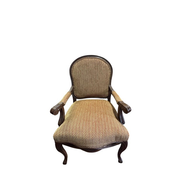 This chair is a Louis XV-style French Provincial armchair, a design from Basset Furniture. The chair features...