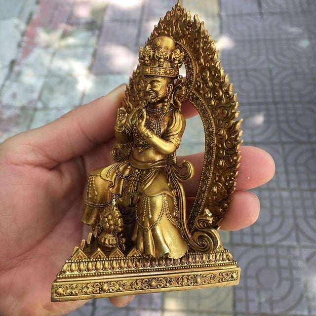 This is a finely detailed vintage gilt bronze figure of Zakiram, a revered Tibetan Buddhist deity. The figure is seated in...