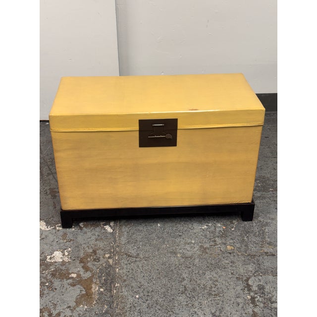 Design Plus Gallery presents a Vintage Chinese Lift-Top Yellow Leather Trunk. This rectangular trunk is wrapped in leather...
