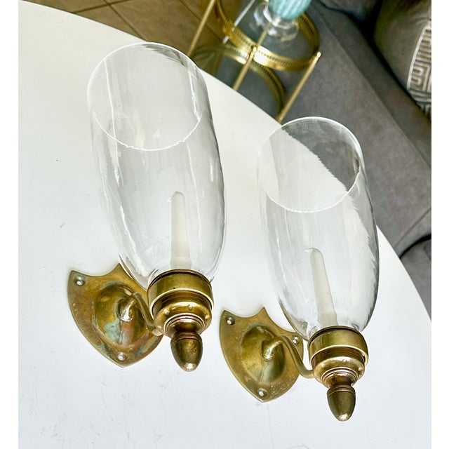 Pair of vintage brass Federal style shield back wall sconces with tall glass hurricane shades by Glo Mar Art Works. Not...