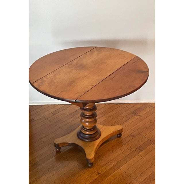 Stunning early Federal maple table. Two beautifully cut leaves open to create a level, firm round-top table. The...